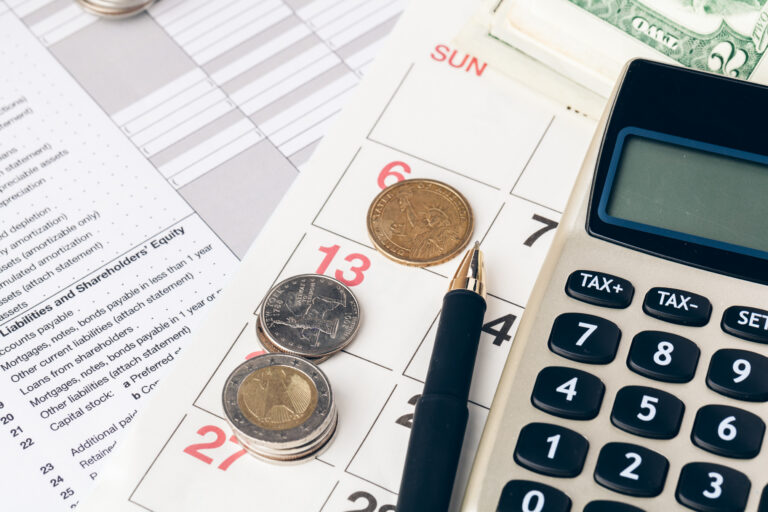 close up of a calculator and coins on a business b 2023 11 27 05 03 13 utc